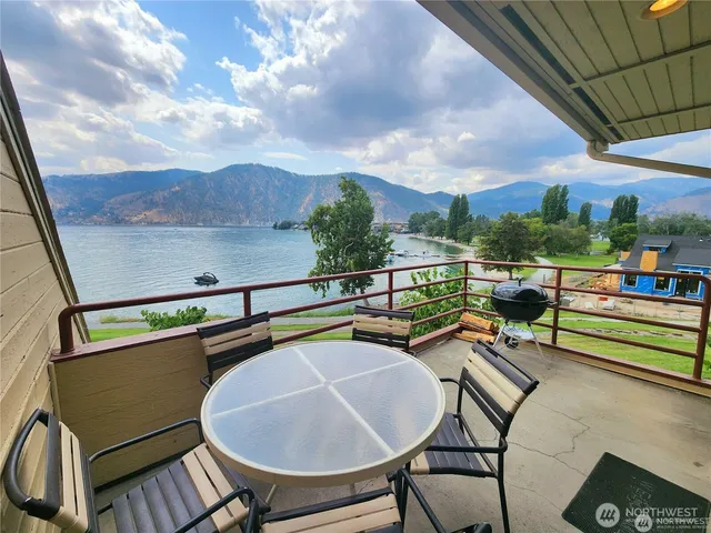 a view of a chairs and table in the balcony