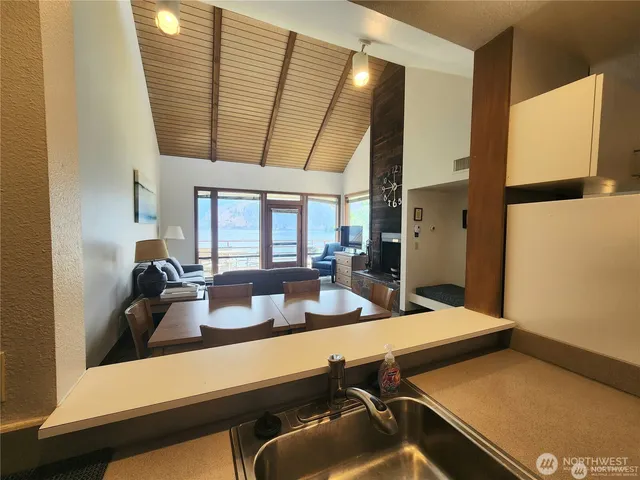 a kitchen with a sink and wooden floor