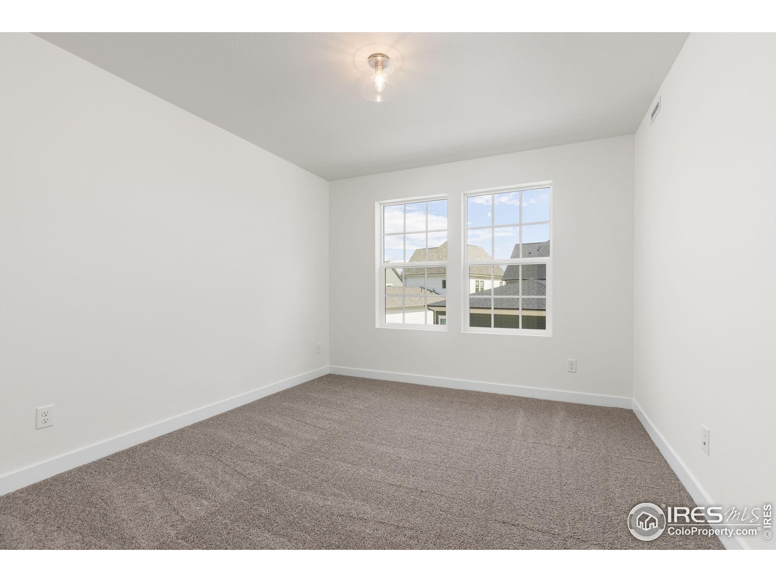 161 Washington Street Erie, CO 80516 - Photo 15 of 19 an empty room with windows