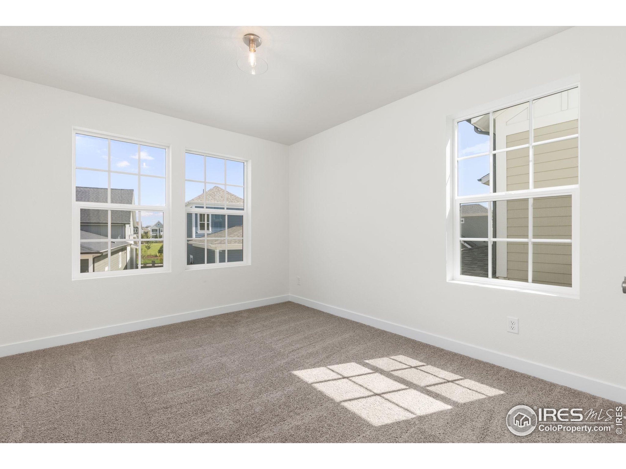 161 Washington Street Erie, CO 80516 - Photo 16 of 19 a view of an empty room with a window