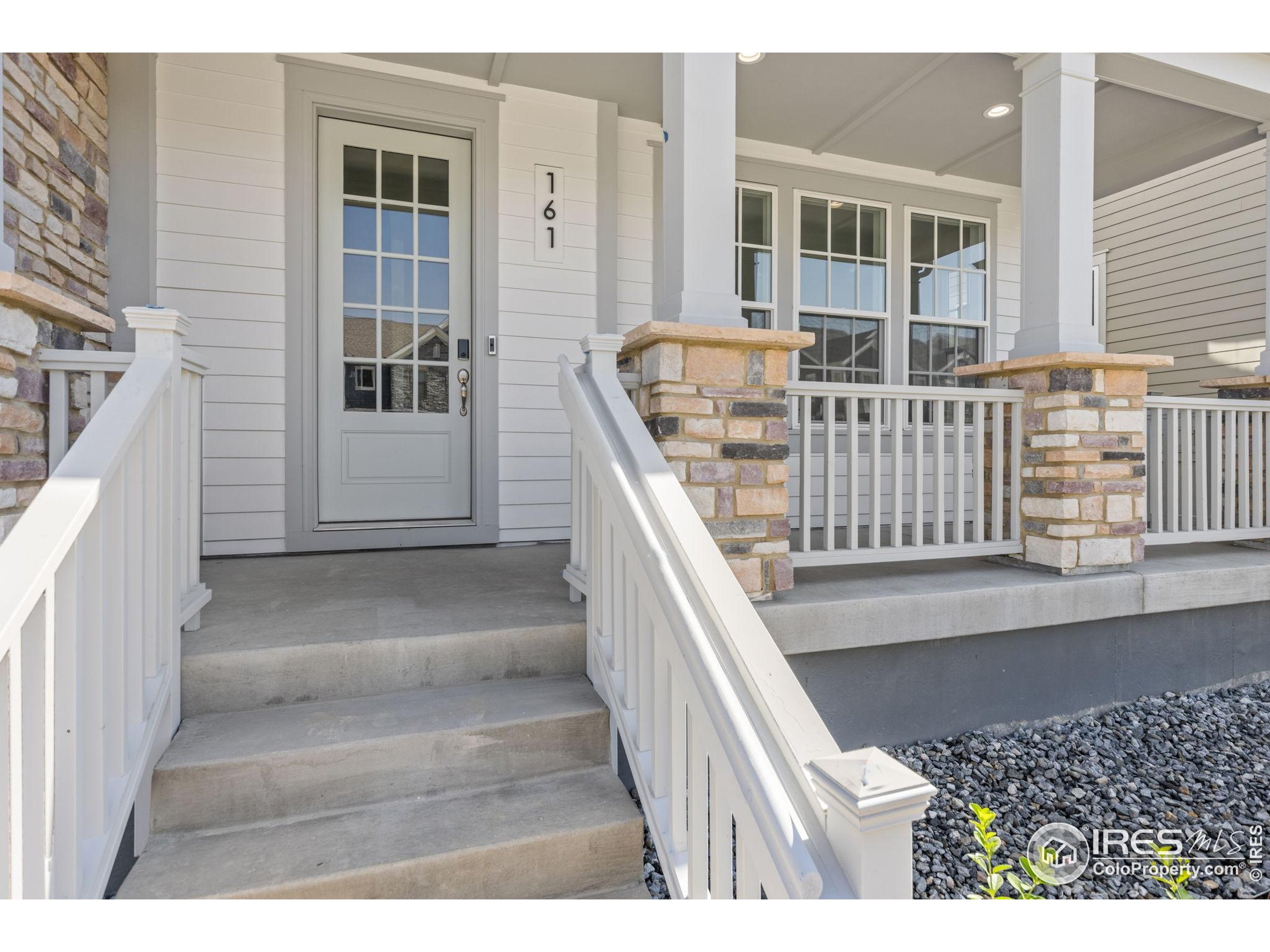 161 Washington Street Erie, CO 80516 - Photo 2 of 19 a view of entryway and hall with wooden floor