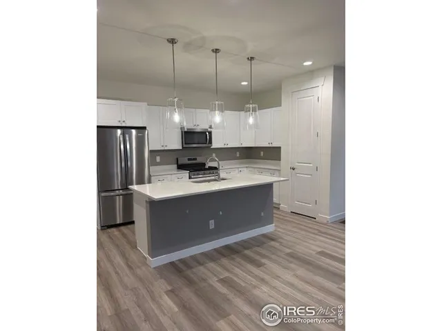 a kitchen with kitchen island cabinets and stainless steel appliances