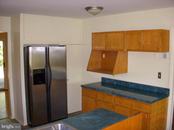 8518 Stevenswood Road Windsor Mill, MD 21244 - Photo 4 of 10 a kitchen with a refrigerator and a sink