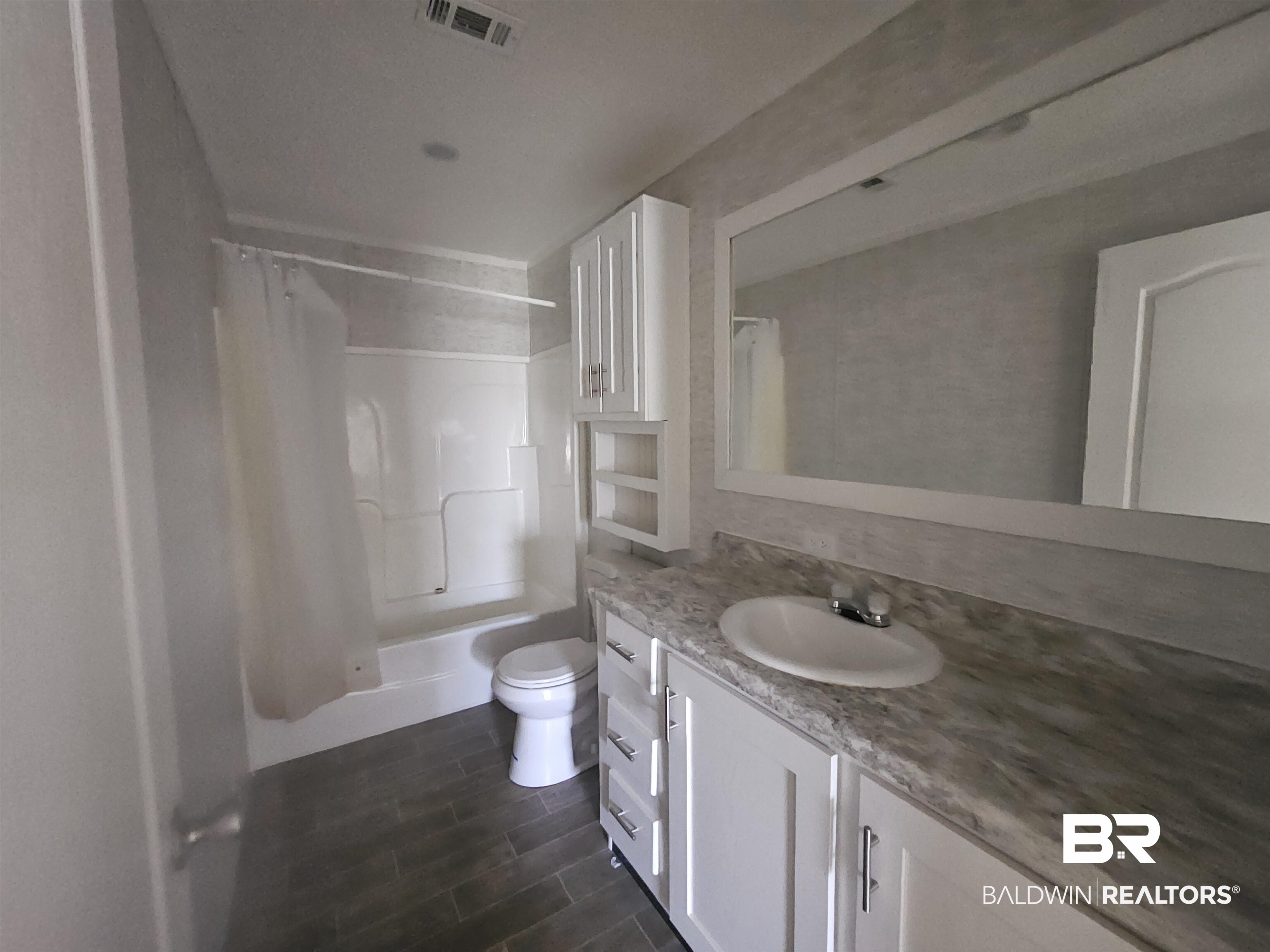 1863 Wait Road Monroeville, AL 36460 - Photo 13 of 38 Full bathroom featuring vanity, toilet, and shower / bathtub combination with curtain