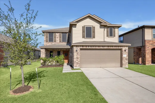a front view of a house with a yard and porch