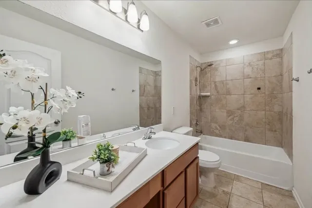 a bath room with a sink mirror and a bath tub