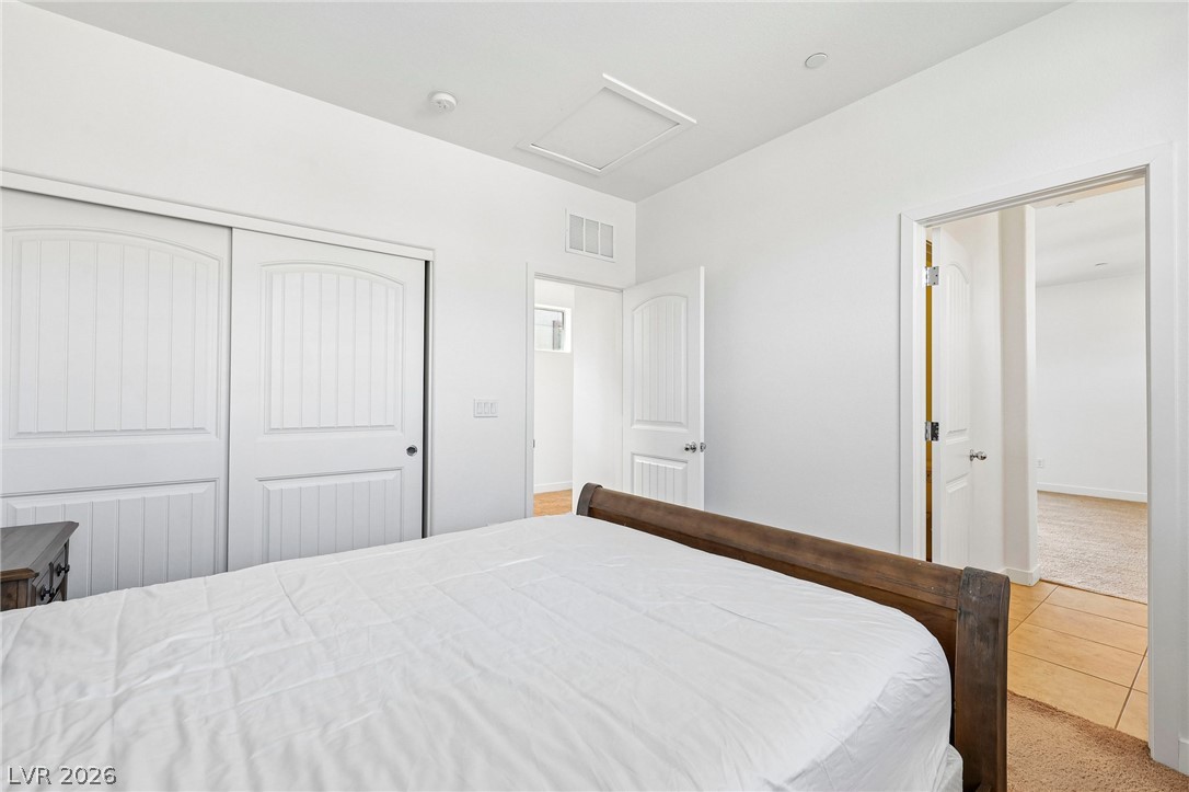 1100 East Sunset Road Henderson, NV 89011 - Photo 36 of 63 Plentiful closet space and neutral carpeting define this comfortable secondary bedroom.