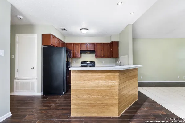 a kitchen with stainless steel appliances granite countertop a refrigerator and a stove