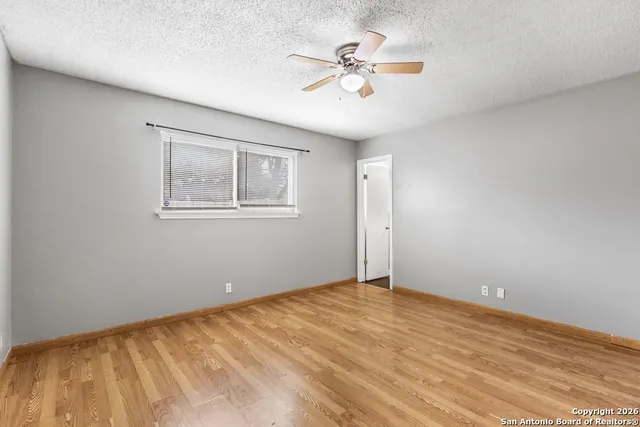 a bathroom with a granite countertop toilet sink and mirror