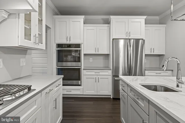 a kitchen with a sink stove and refrigerator