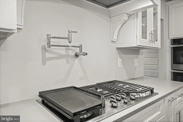 a stove top oven sitting inside of a kitchen