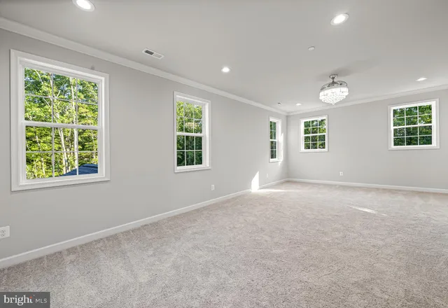 an empty room with windows and painted walls