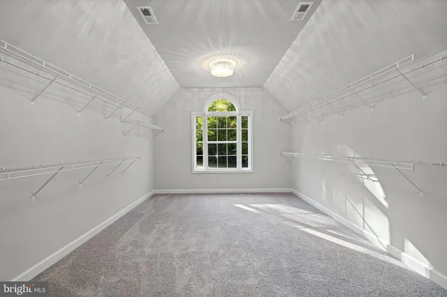 a spacious bathroom with a double vanity sink a mirror and a bathtub