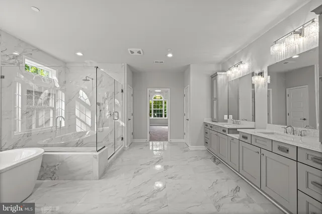 a bathroom with a tub a sink and a shower