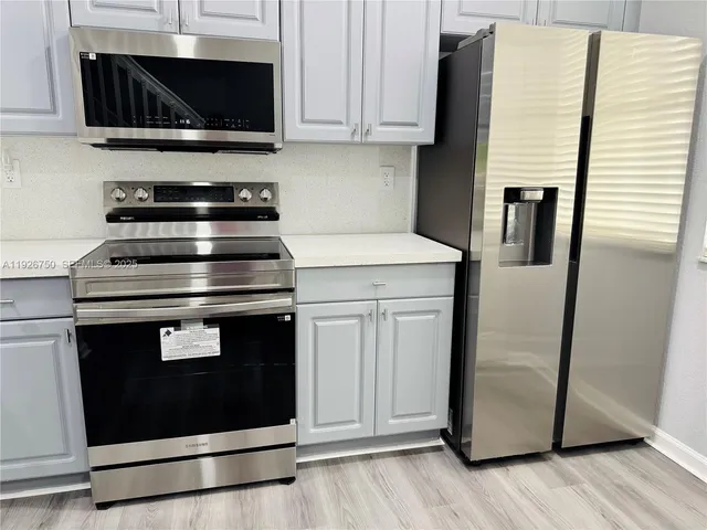 a stove top oven sitting inside of a kitchen