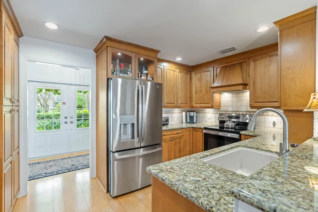 a bedroom with a granite countertop sink and chandelier