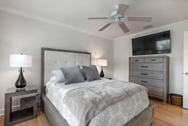 a living room with furniture a flat screen tv and a large window