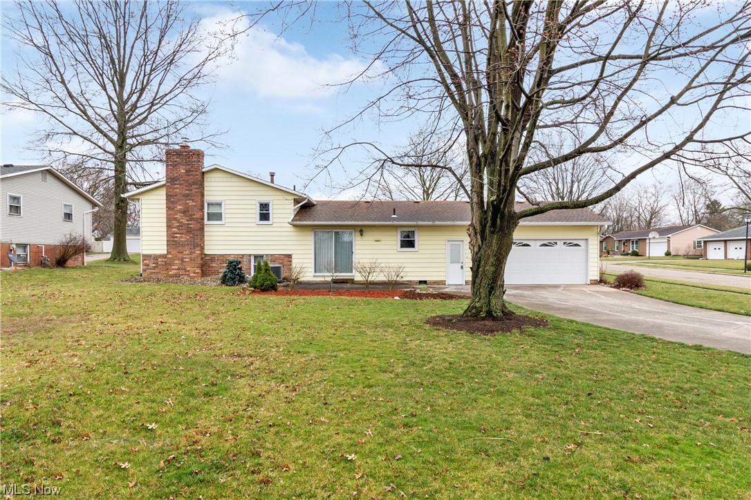 41 Willard Street Rittman, OH 44270 - Photo 23 of 25 View of front of home featuring a garage and a front yard