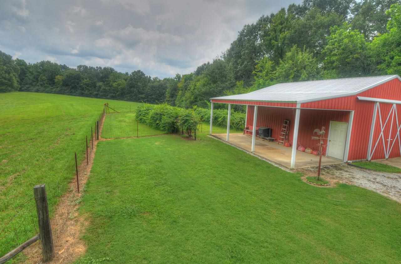 2375 Stanton Koko Road Stanton, TN 38069 - Photo 4 of 25 a view of a backyard with table and chairs with wooden fence