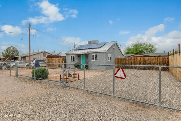 a view of a house with wooden fence