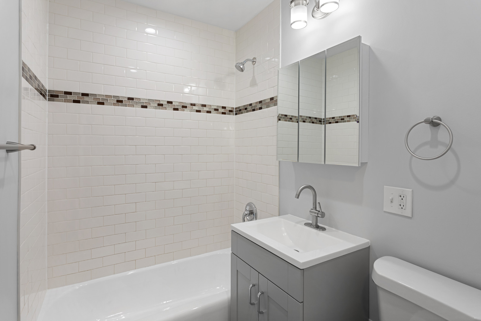 6826 North Ridge Boulevard, Unit 202 Chicago, IL 60645 - Photo 11 of 15 a bathroom with a sink a toilet and shower