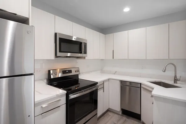 a kitchen with a refrigerator stove and sink