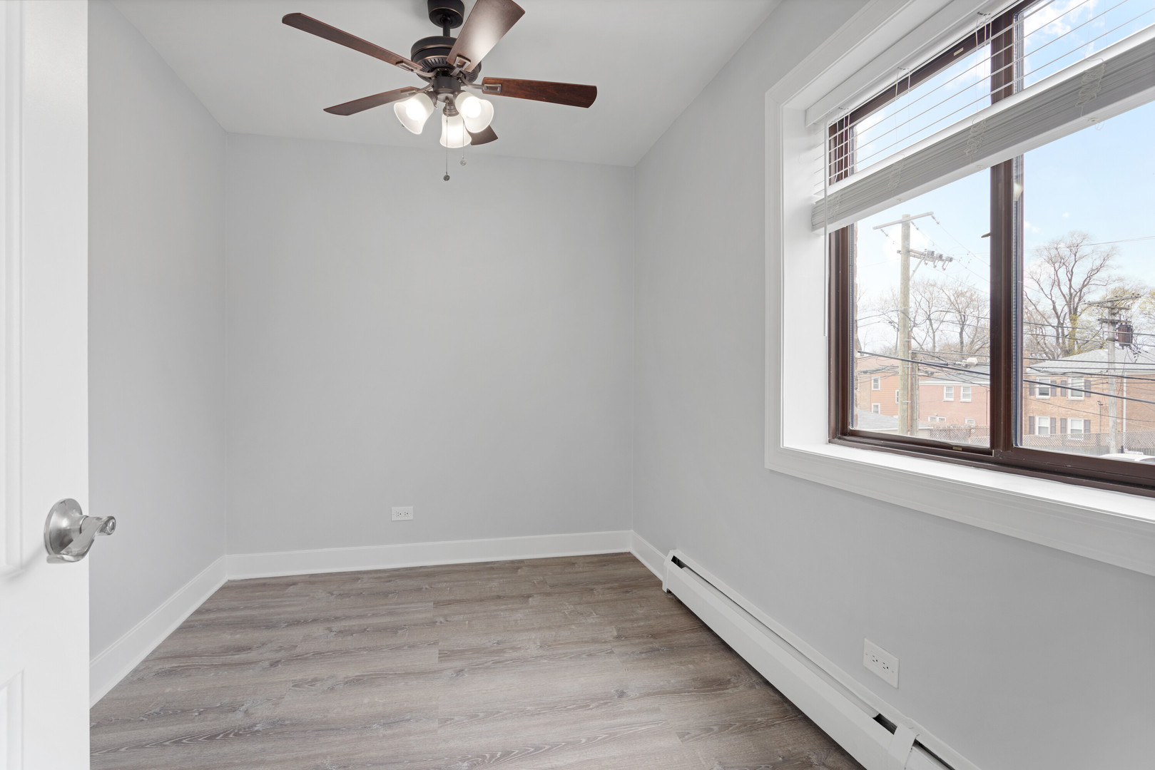 6826 North Ridge Boulevard, Unit 202 Chicago, IL 60645 - Photo 9 of 15 wooden floor in an empty room with a window