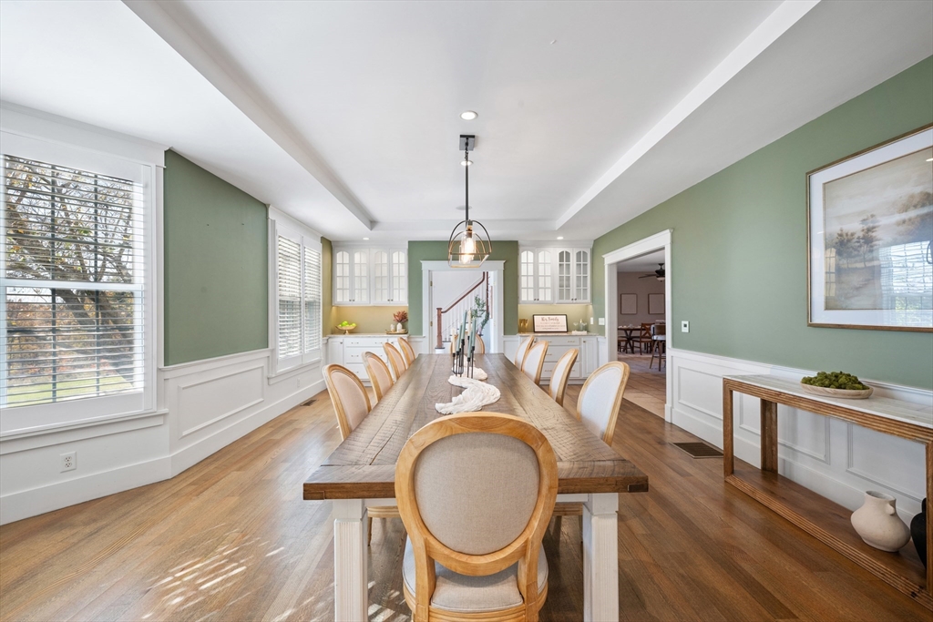 6 Brickyard Road Leicester, MA 01524 - Photo 18 of 41 a dining room with wooden floor a chandelier a wooden table and chairs