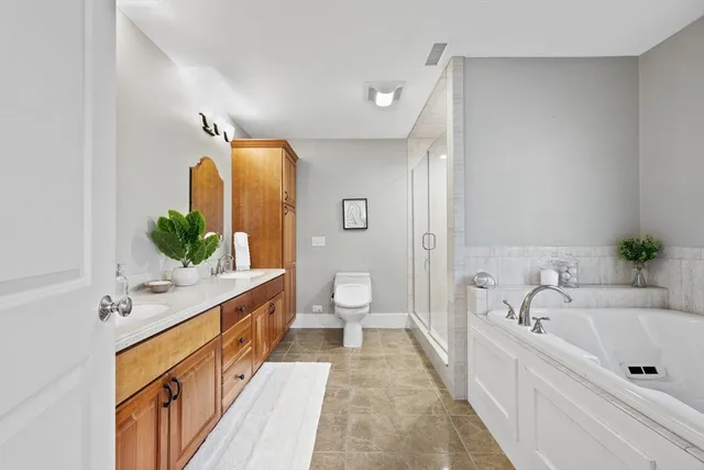 a spacious bathroom with a tub sink and mirror