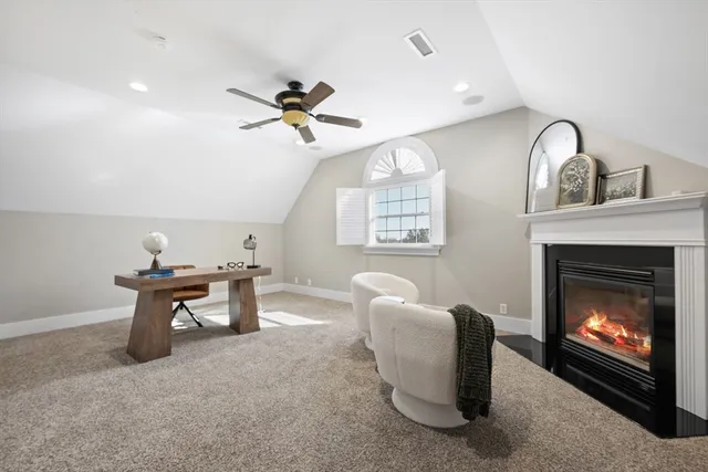 a living room with furniture a window and a fireplace