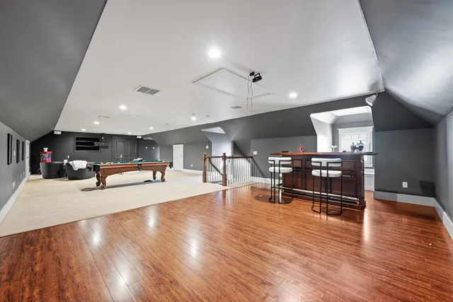 a living room with lots of furniture and a wooden floor
