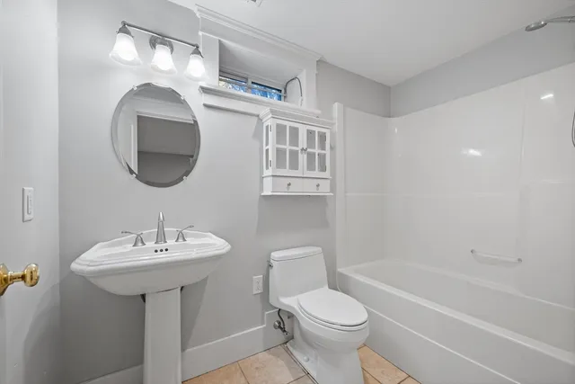 a bathroom with a sink a toilet and bathtub