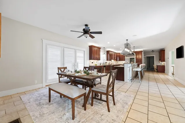 a living room with furniture a dining table and a fireplace