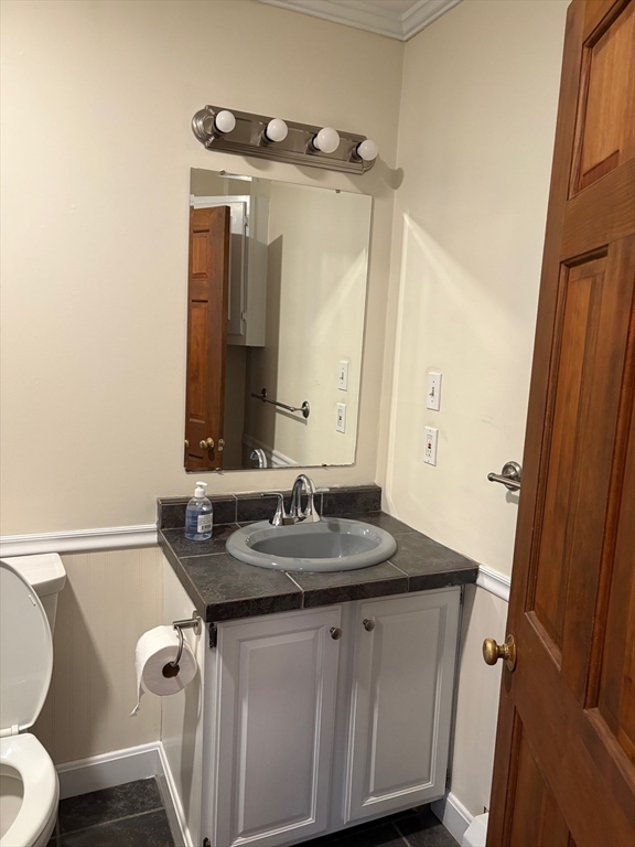 258 Elm Street, Unit REAR Amesbury, MA 01913 - Photo 11 of 12 a bathroom with a granite countertop sink and a mirror