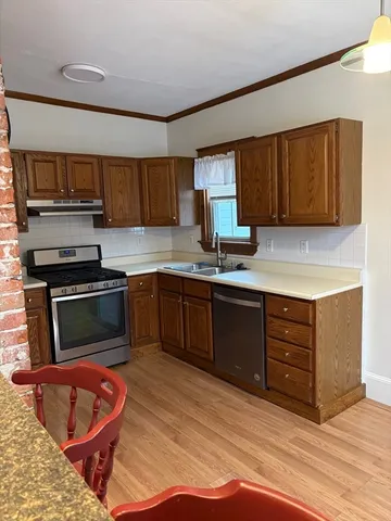 a kitchen with stainless steel appliances granite countertop a stove a sink and a refrigerator