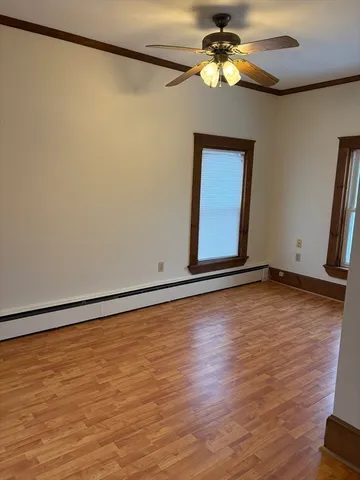 a view of room with window and wooden floor