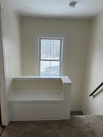 a bathroom with bathtub and window