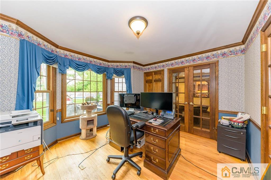 23 Covered Bridge Road Branchburg, NJ 08853 - Photo 11 of 25 a workspace with furniture and a flat screen tv