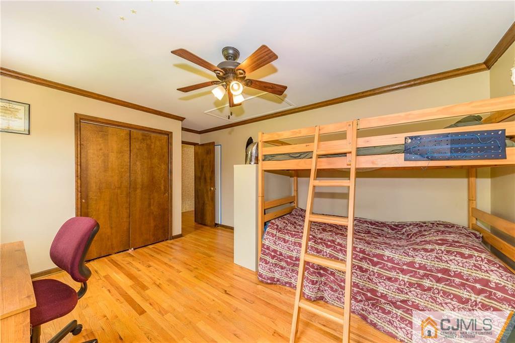 23 Covered Bridge Road Branchburg, NJ 08853 - Photo 18 of 25 a bedroom with a bed and wooden floor