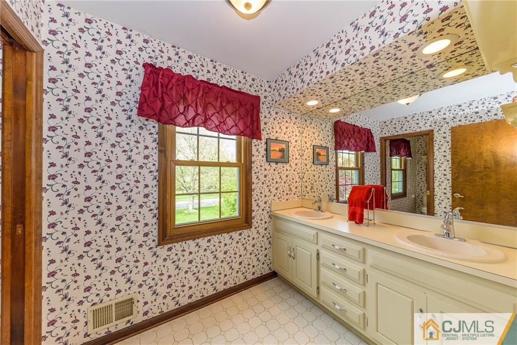 23 Covered Bridge Road Branchburg, NJ 08853 - Photo 20 of 25 a bathroom with a sink and a mirror
