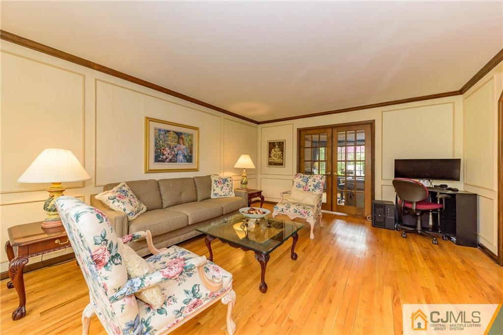 23 Covered Bridge Road Branchburg, NJ 08853 - Photo 3 of 25 a living room with furniture and a flat screen tv