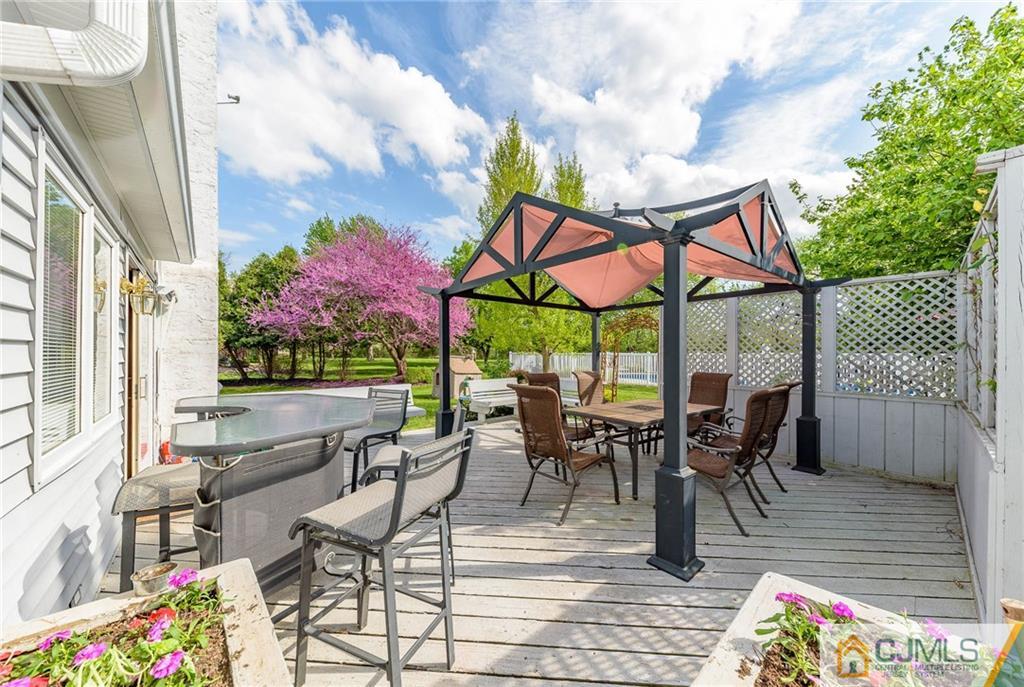 23 Covered Bridge Road Branchburg, NJ 08853 - Photo 21 of 25 a view of a patio with dining table and chairs