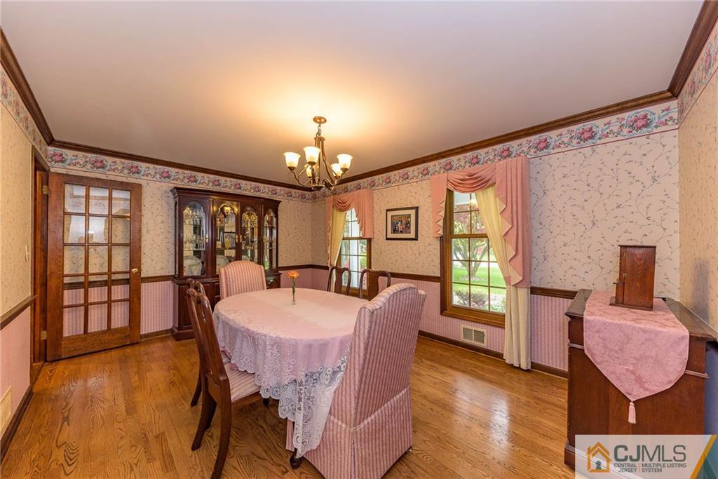 23 Covered Bridge Road Branchburg, NJ 08853 - Photo 4 of 25 a view of a dining room with furniture a chandelier and wooden floor