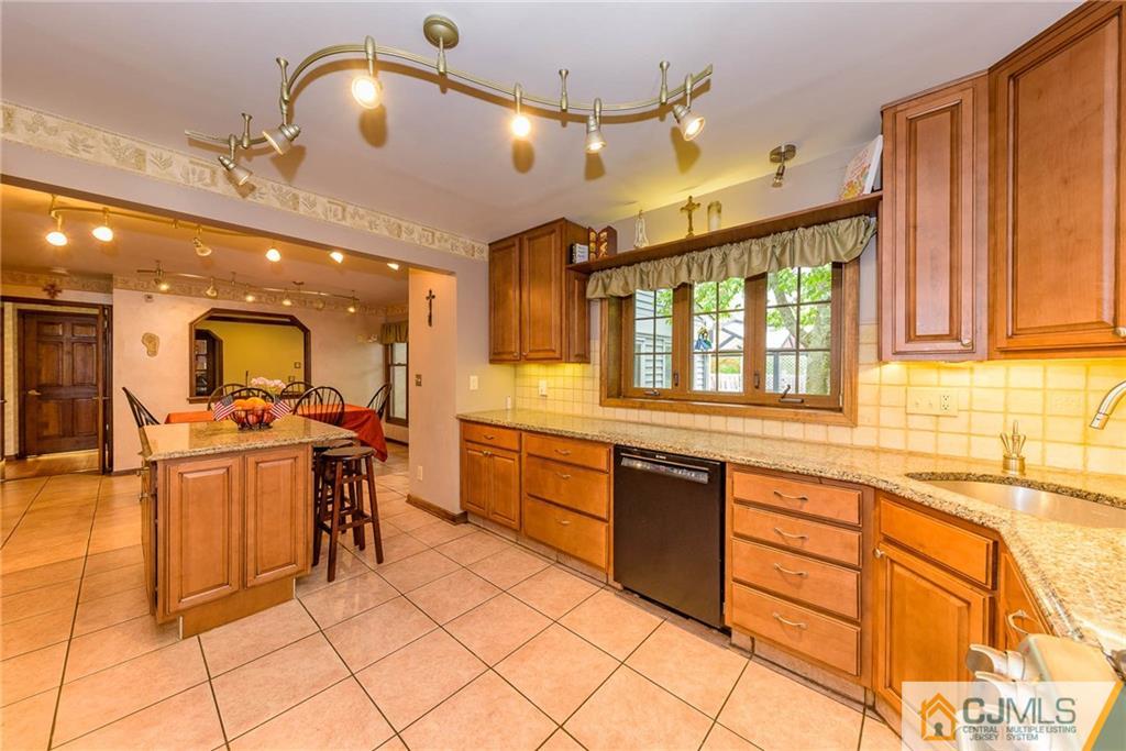 23 Covered Bridge Road Branchburg, NJ 08853 - Photo 8 of 25 a large kitchen with kitchen island granite countertop a large counter top space appliances and cabinets