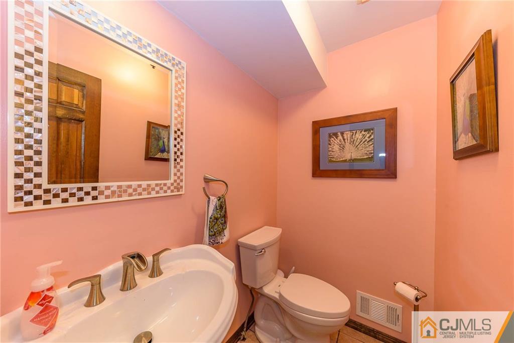 23 Covered Bridge Road Branchburg, NJ 08853 - Photo 9 of 25 a white toilet sitting next to a bathroom sink
