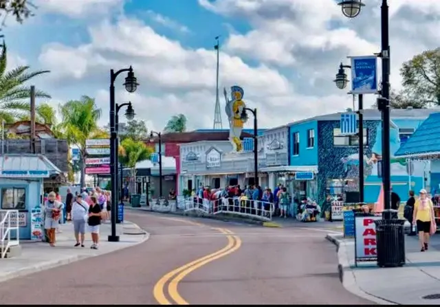 a group of people sitting in front of retail shop