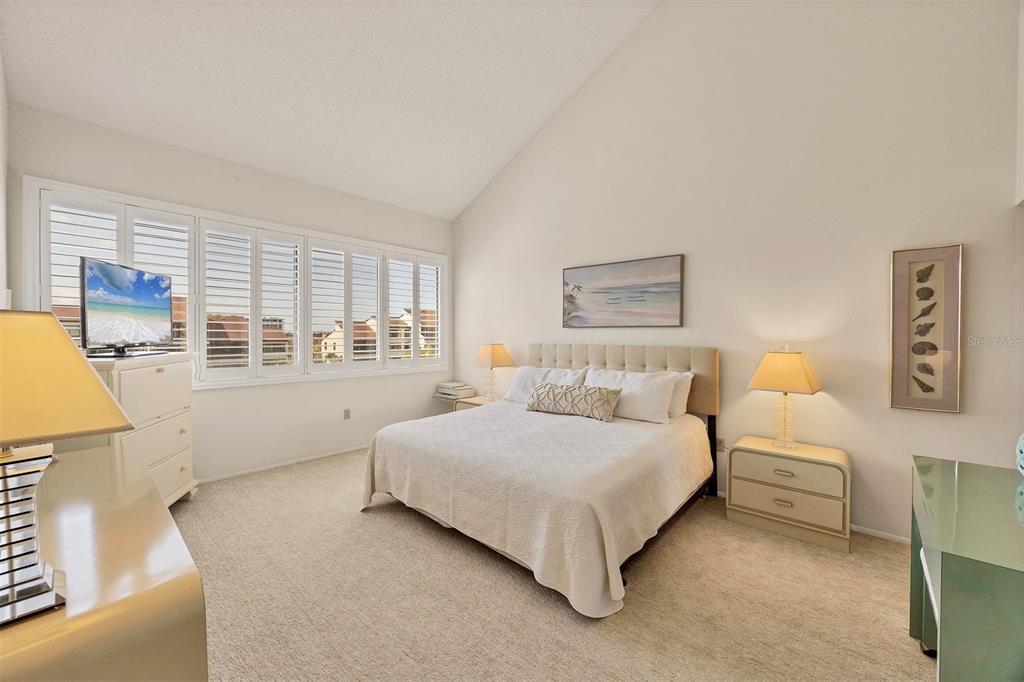 6285 Midnight Pass Road, Unit 403 Sarasota, FL 34242 - Photo 15 of 53 a bedroom with a large bed and a window