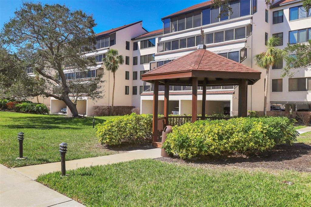 6285 Midnight Pass Road, Unit 403 Sarasota, FL 34242 - Photo 36 of 53 a front view of a house with a yard