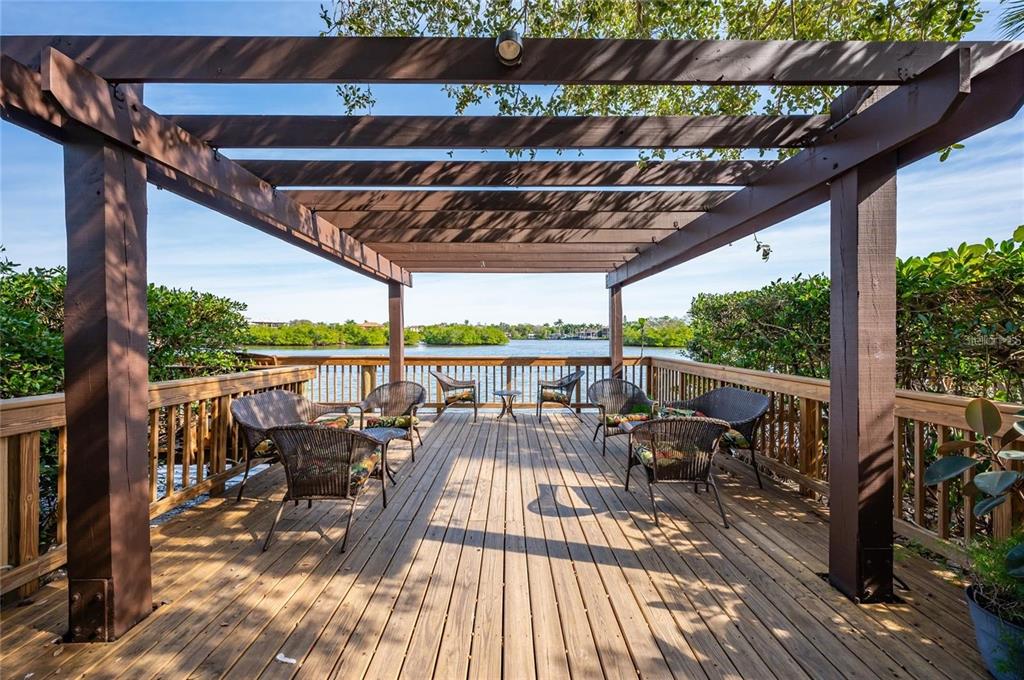 6285 Midnight Pass Road, Unit 403 Sarasota, FL 34242 - Photo 38 of 53 a view of balcony with chairs and wooden floor