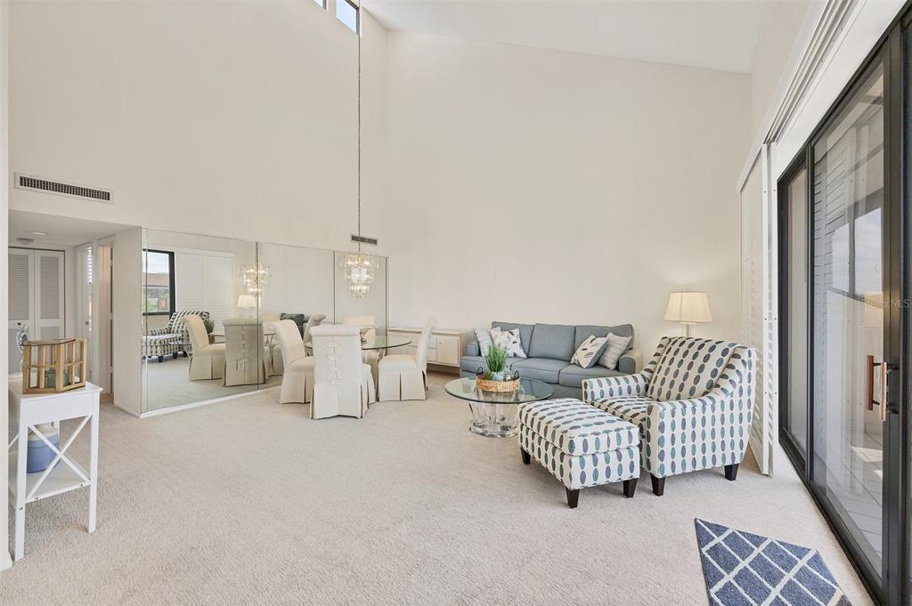 6285 Midnight Pass Road, Unit 403 Sarasota, FL 34242 - Photo 5 of 53 a living room with furniture and a chandelier